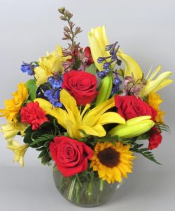 Colorful bouquet of roses, sunflowers, and lilies. Very bright