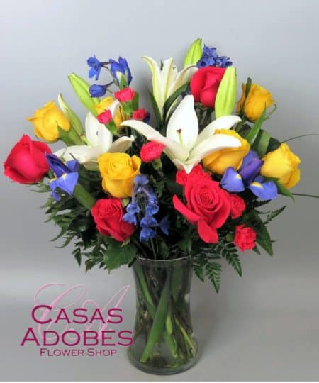 A colorful burst of roses and iris form a charming bouquet of spring sophistication and timeless elegance. Yellow roses,purple iris, fuchsia roses and white Oriental lilies are brought together to create a stunning flower bouquet 